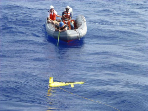 Small boat crew filming a T-glider in trial deployment
