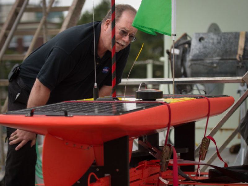 Eric Lindstrom inspects a wave glider